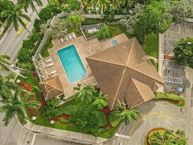 a view of a white building with a swimming pool