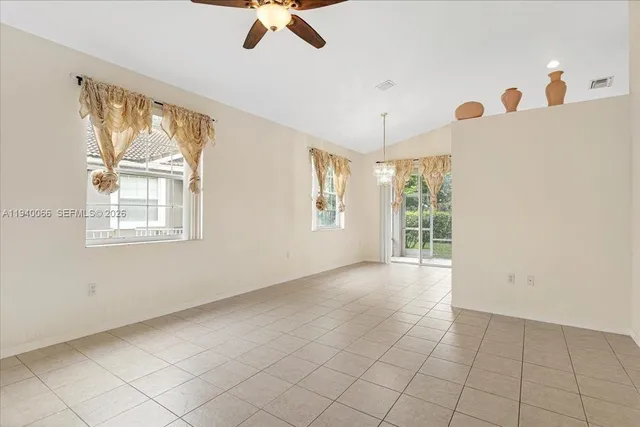 a view of a kitchen with an entryway and chandelier fan