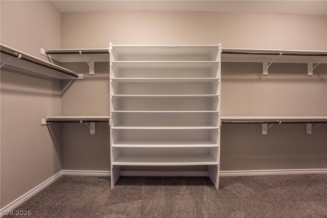 2787 Athens Ridge Drive Henderson, NV 89052 - Photo 16 of 31 Ample shelving and hanging space create an organized primary walk-in closet.