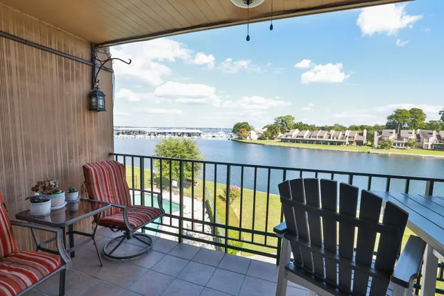 a view of a balcony with wooden chairs