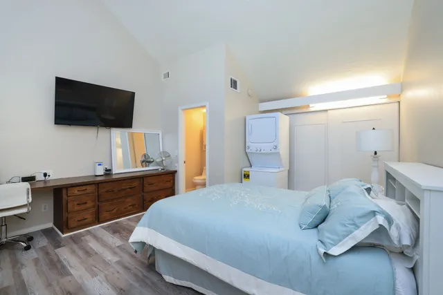 a bed room with a bed and a television