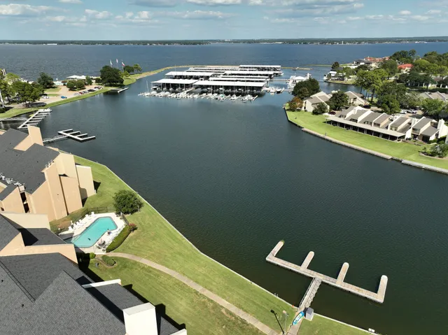 an aerial view of a house with a garden and lake view