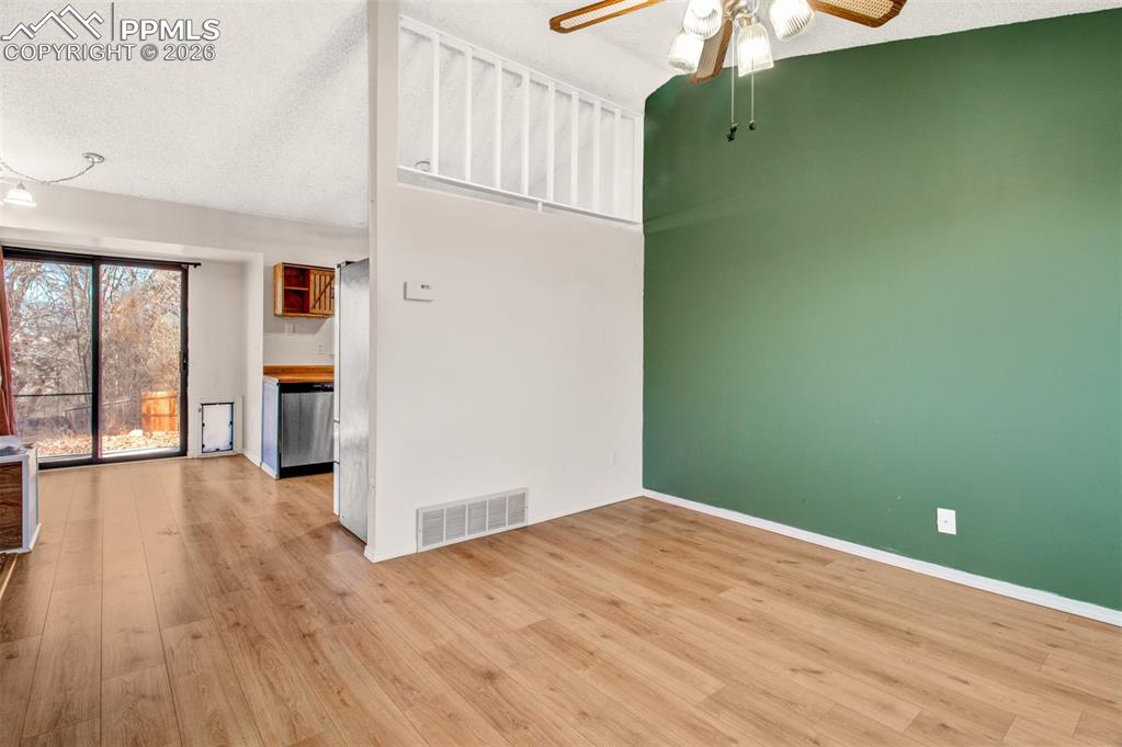 541 Blossom Field Road Fountain, CO 80817 - Photo 4 of 35 an empty room with wooden floor and a window