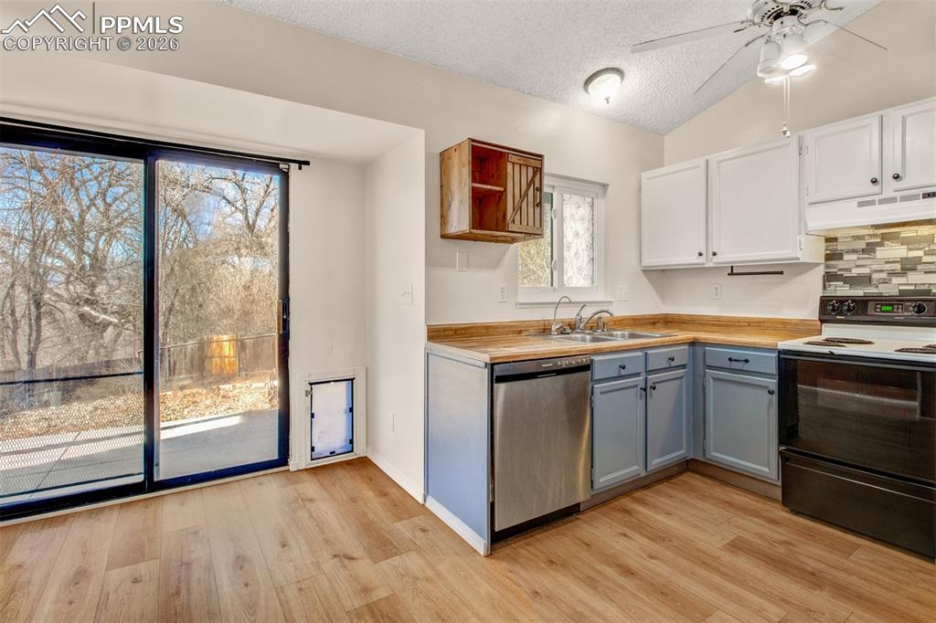 541 Blossom Field Road Fountain, CO 80817 - Photo 5 of 35 a kitchen with stainless steel appliances granite countertop a stove a sink and a refrigerator