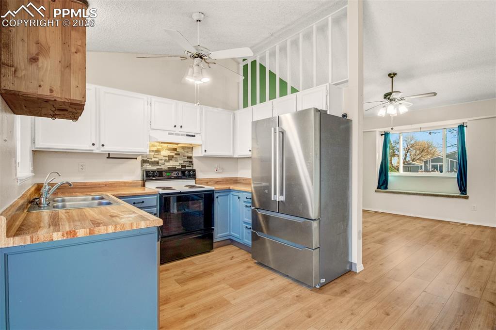 541 Blossom Field Road Fountain, CO 80817 - Photo 6 of 35 a kitchen with stainless steel appliances a refrigerator sink and stove