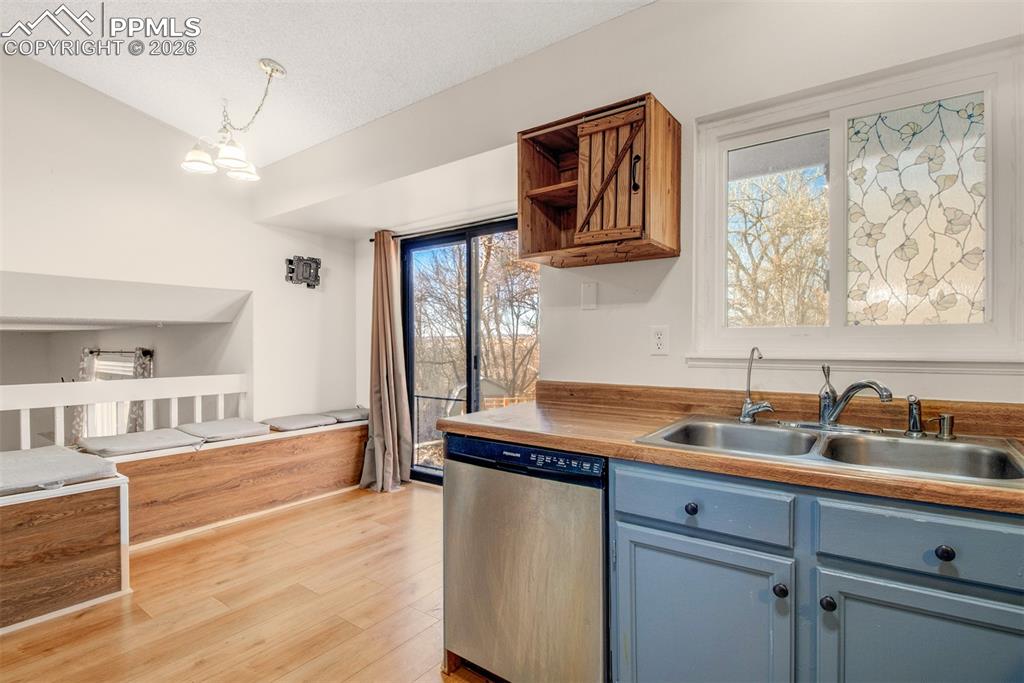 541 Blossom Field Road Fountain, CO 80817 - Photo 7 of 35 a kitchen with stainless steel appliances a sink dishwasher a refrigerator and cabinets with wooden floor