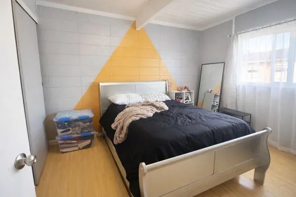 a bedroom with a bed and window