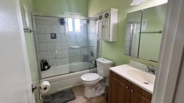 a bathroom with a shower a toilet and sink