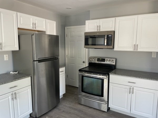 253 Draper Street Springfield, MA 01108 - Photo 11 of 38 a kitchen with cabinets stainless steel appliances and a counter space