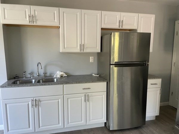 253 Draper Street Springfield, MA 01108 - Photo 12 of 38 a kitchen with cabinets and stainless steel appliances