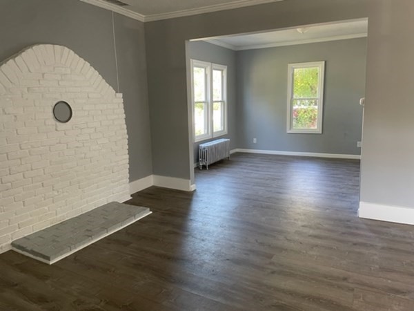 253 Draper Street Springfield, MA 01108 - Photo 6 of 38 an empty room with wooden floor and windows