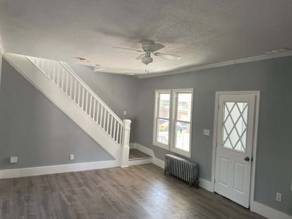 253 Draper Street Springfield, MA 01108 - Photo 8 of 38 a view of an entryway with wooden floor and stairs