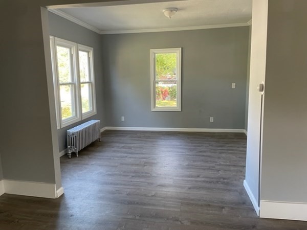 253 Draper Street Springfield, MA 01108 - Photo 9 of 38 an empty room with wooden floor and windows