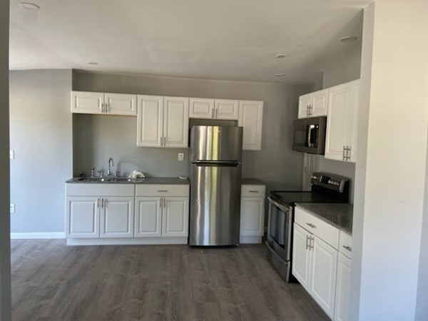 253 Draper Street Springfield, MA 01108 - Photo 10 of 38 a kitchen with granite countertop a refrigerator stove and sink
