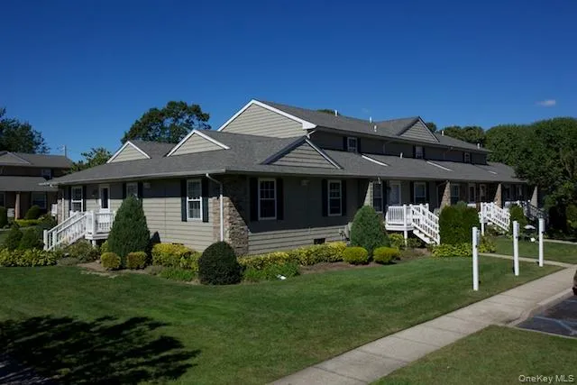 a front view of a house with a yard table and chairs