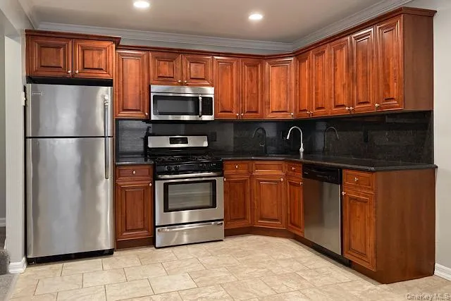 a kitchen with stainless steel appliances granite countertop a refrigerator and a sink