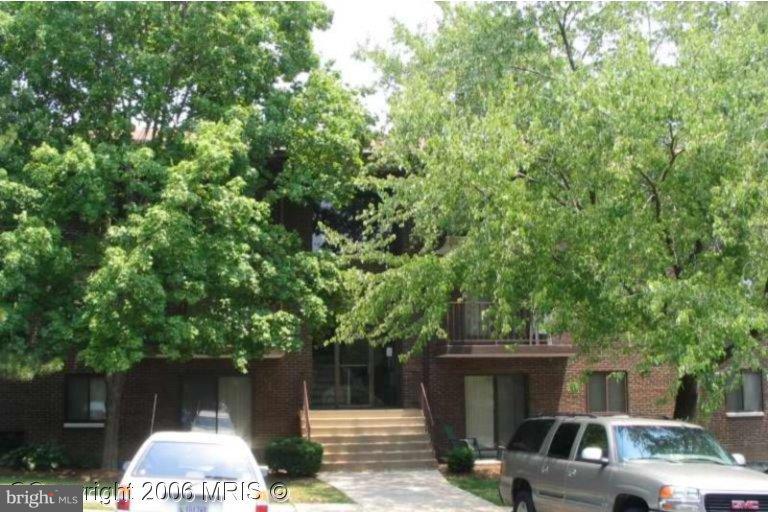 6230 Edsall Road, Unit 304 Alexandria, VA 22312 - Photo 1 of 1 a front view of a house with a yard