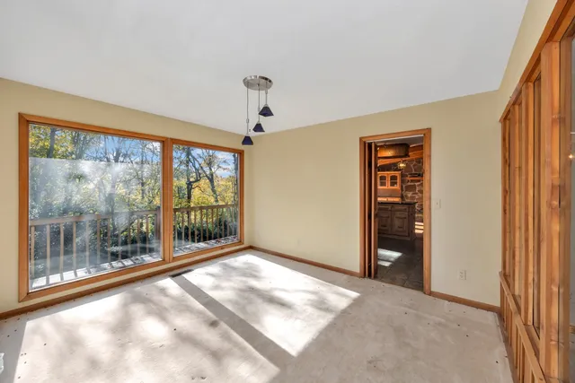 a view of balcony with wooden fence and trees