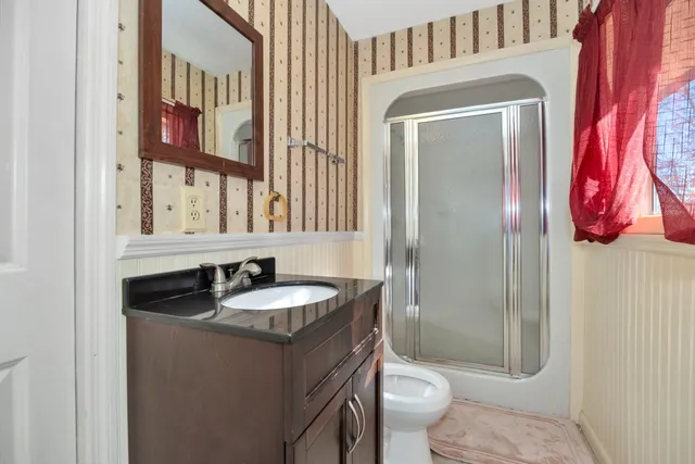 a bathroom with a shower and a toilet
