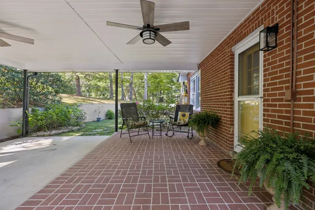 a kitchen with stainless steel appliances granite countertop a sink a stove and a white cabinets