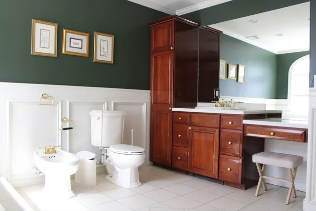 a bathroom with a toilet sink and mirror