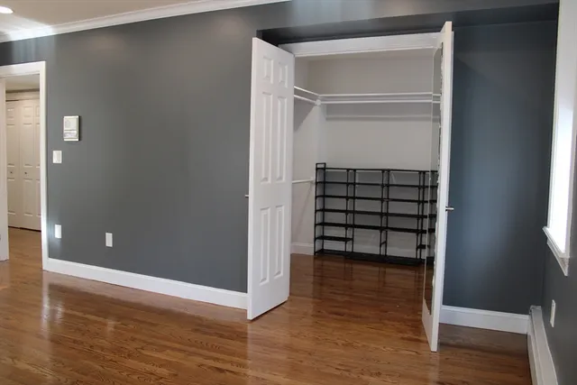 a view of walk in closet with empty racks