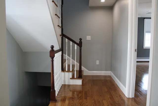a view of entryway and gallery with wooden floor