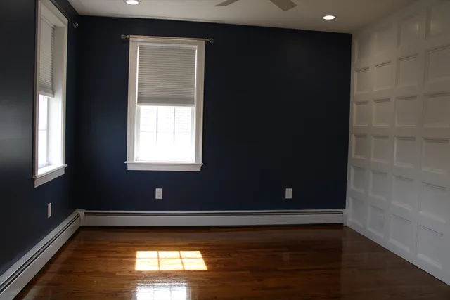 a view of room with window and wooden floor