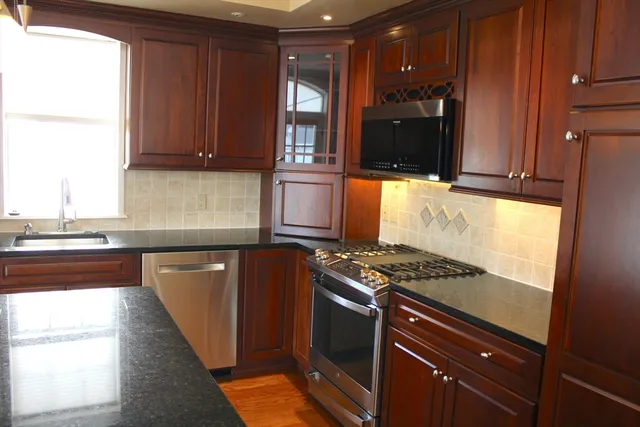 a kitchen with granite countertop a stove and a refrigerator