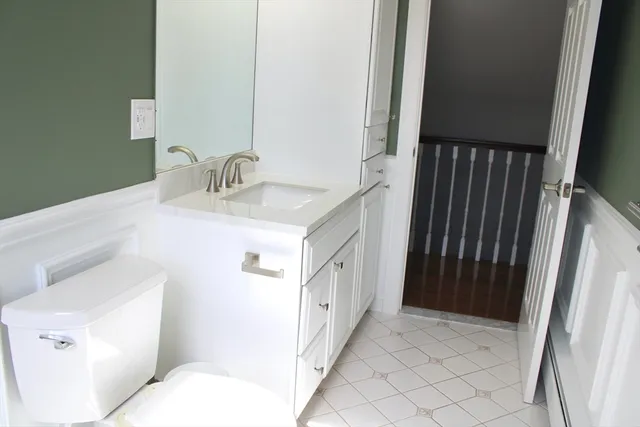 a bathroom with a sink a toilet and a mirror