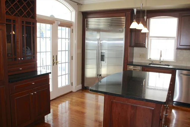 a kitchen with a window a sink and cabinets