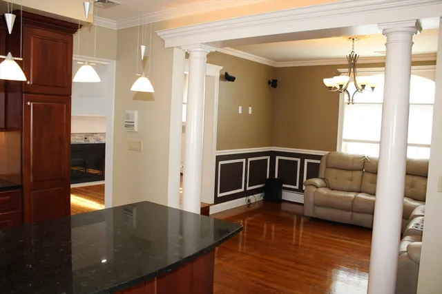 a living room with furniture and a chandelier