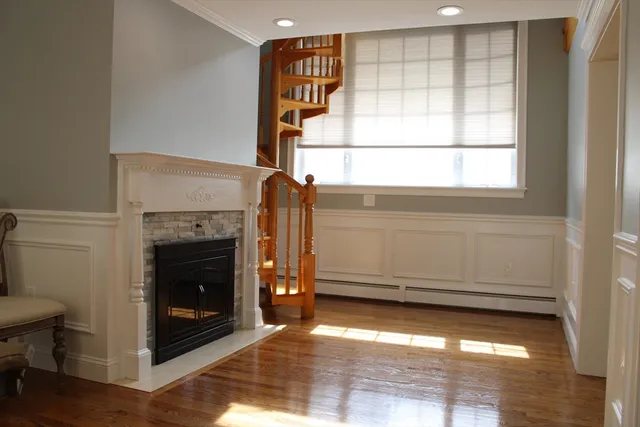 a view of a livingroom with a fireplace and window