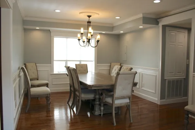 a view of a dining room with furniture wooden floor and chandelier