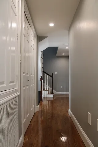 a view of a hallway with wooden floor