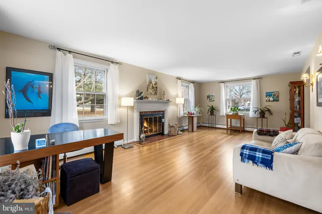 a living room with furniture a fireplace and a window