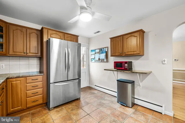 a kitchen with stainless steel appliances granite countertop a refrigerator stove and sink