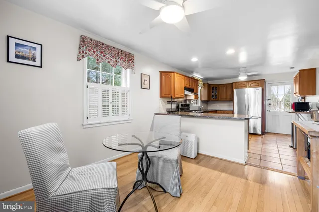a open dining room with stainless steel appliances kitchen island granite countertop furniture and a kitchen view