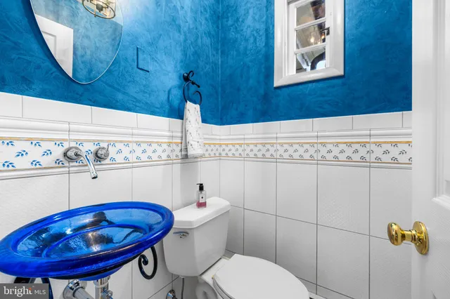 a bathroom with a toilet a sink and mirror