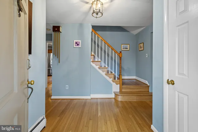 a view of entryway and hall with wooden floor