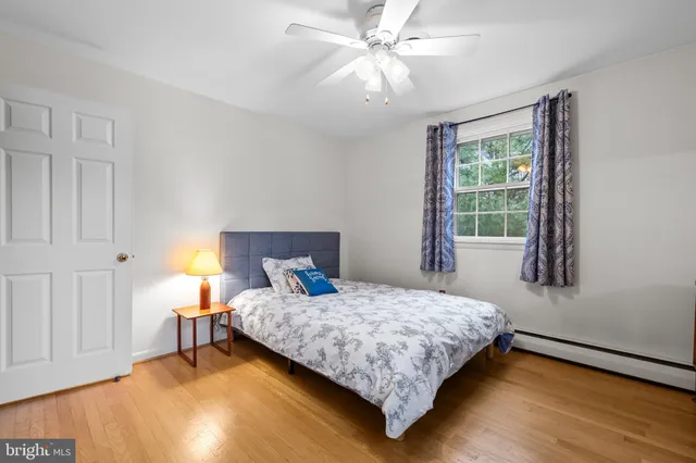a bathroom with a granite countertop sink a window and a shower
