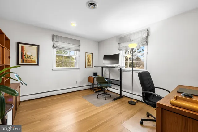 a view of a workspace with furniture and a bathroom