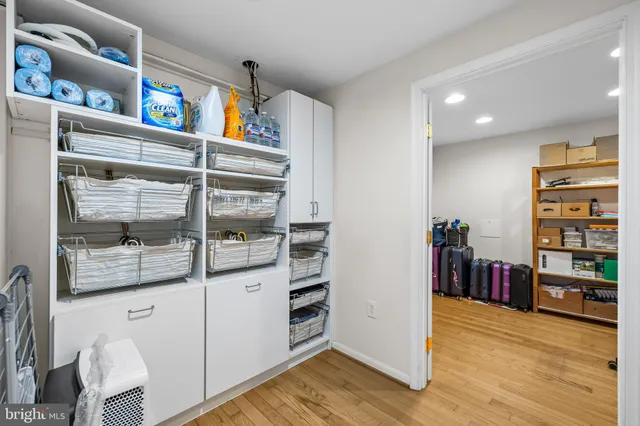 a view of a workspace with furniture and wooden floor