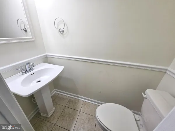 a bathroom with a sink mirror vanity and toilet