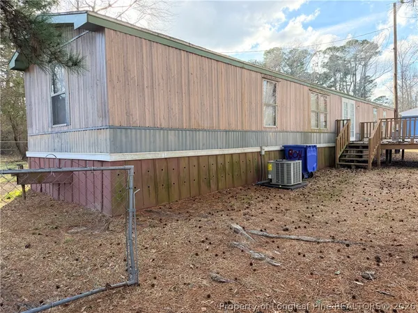 a view of a yard with a tiny house and a tree