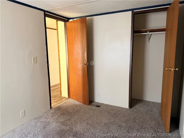 a view of closet with wooden floor