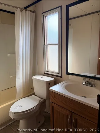 a white toilet sitting next to a bath tub