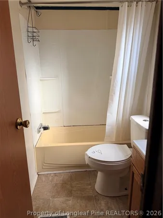 a view of a room with wooden floor and a window
