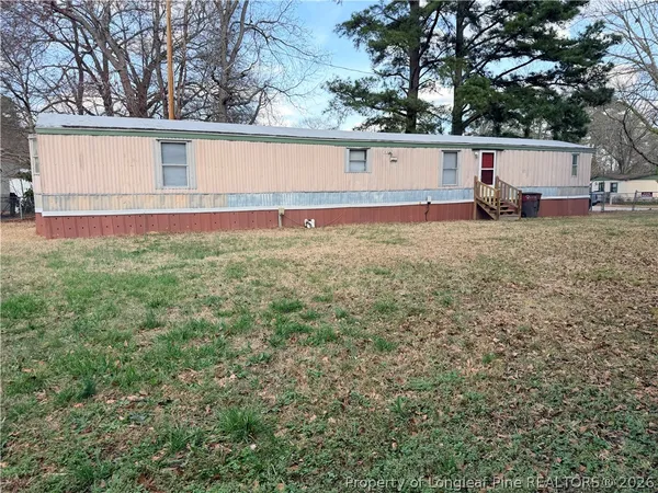 a view of house with backyard and a garden
