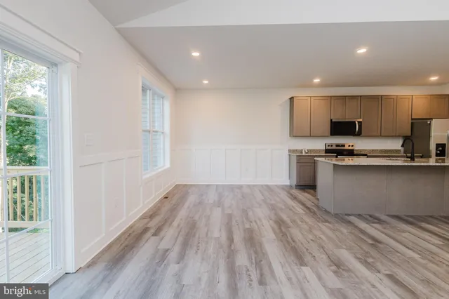 a view of a kitchen with a sink and a fireplace
